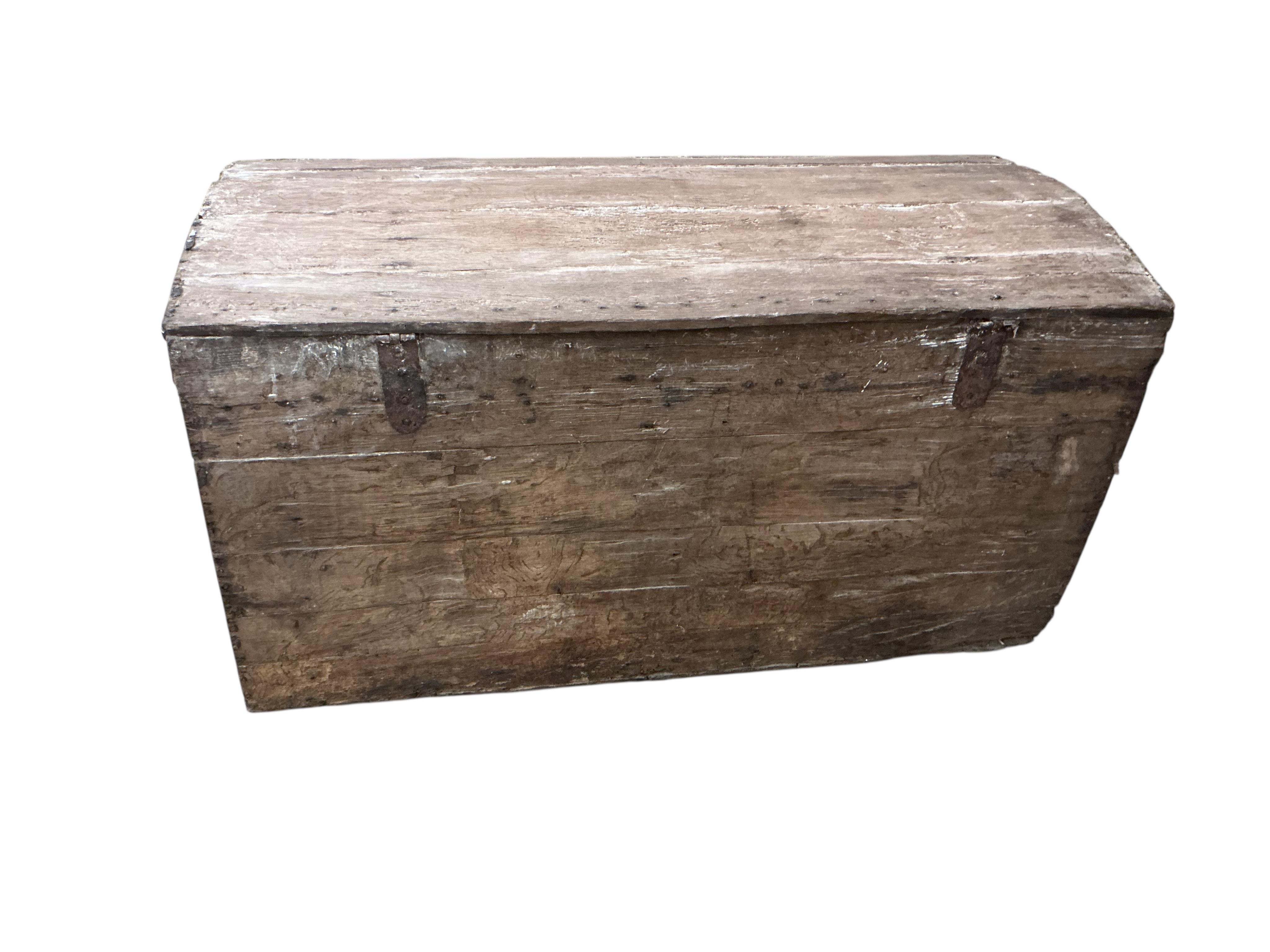 An 18th century oak domed trunk the front with the remnants of studded leather work, width 118cm, depth 53cm, height 65cm
